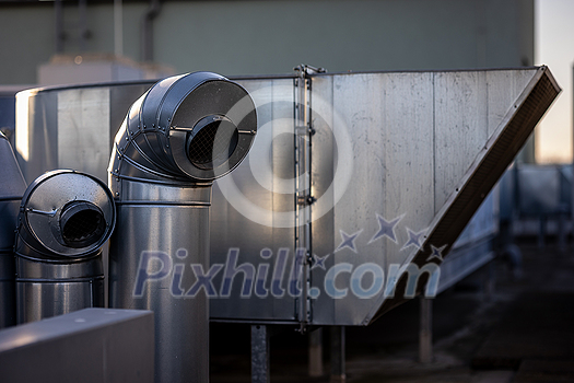 External unit of commercial air conditioning and ventilation system installed on industrial building roof. Exhaust vent on flat factory rooftop External unit of commercial air conditioning and ventilation system installed on industrial building roof. Exhaust vent on flat factory rooftop