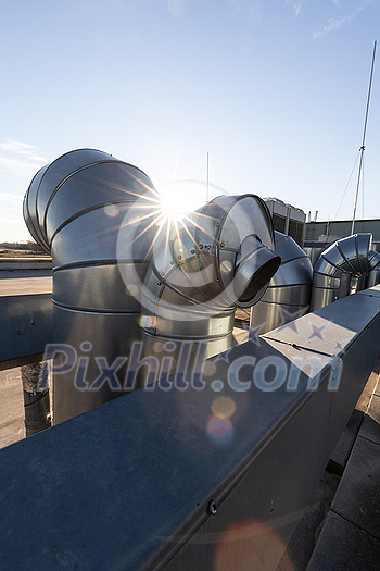 External unit of commercial air conditioning and ventilation system installed on industrial building roof. Exhaust vent on flat factory rooftop External unit of commercial air conditioning and ventilation system installed on industrial building roof. Exhaust vent on flat factory rooftop