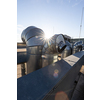 External unit of commercial air conditioning and ventilation system installed on industrial building roof. Exhaust vent on flat factory rooftop