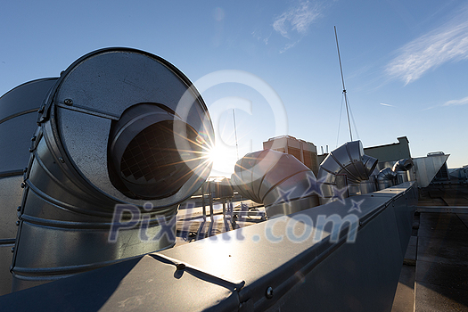 External unit of commercial air conditioning and ventilation system installed on industrial building roof. Exhaust vent on flat factory rooftop External unit of commercial air conditioning and ventilation system installed on industrial building roof. Exhaust vent on flat factory rooftop