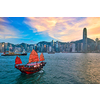 Hong Kong skyline cityscape downtown skyscrapers over Victoria Harbour in the evening with junk tourist ferry boat on sunset with dramatic sky. Hong Kong, China