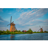 Netherlands rural lanscape with windmills at famous tourist site Kinderdijk in Holland on sunset with dramatic sky