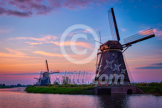 Netherlands rural lanscape with windmills at famous tourist site Kinderdijk in Holland on sunset with dramatic sky Netherlands rural lanscape with windmills at famous tourist site Kinderdijk in Holland on sunset with dramatic sky