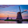 Netherlands rural lanscape with windmills at famous tourist site Kinderdijk in Holland on sunset with dramatic sky