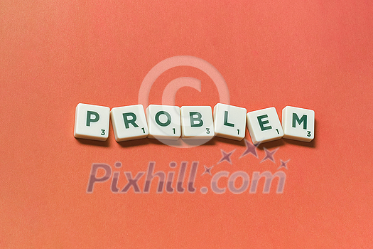 Problem word formed of scrabble blocks on red background. Creative template with copy space.