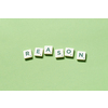 Reason word formed of scrabble tiles on green background. Creative business postcard idea in pastel palette.