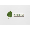 Fuel word formed of scrabble tiles with green tree leaf on white background. Nature and renewable energy concept.