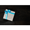 Gift birthday Christmas present concept - silver gift box with blue ribbon on dark wooden background