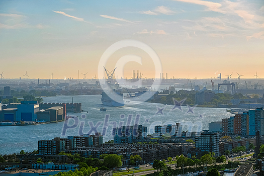 View of Rotterdam port and Nieuwe Maas river with cruise liner ship on sunset View of Rotterdam port and Nieuwe Maas river with cruise liner ship on sunset