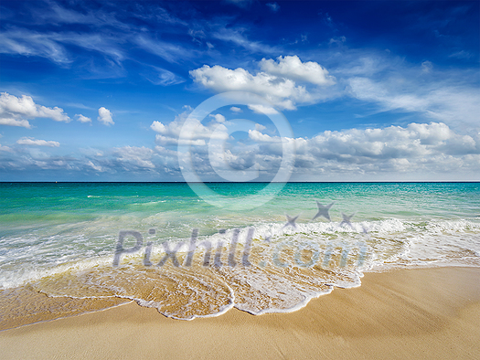 Beach holidays vacation background - beautiful beach and waves of Caribbean Sea Beach holidays vacation background - beautiful beach and waves of Caribbean Sea