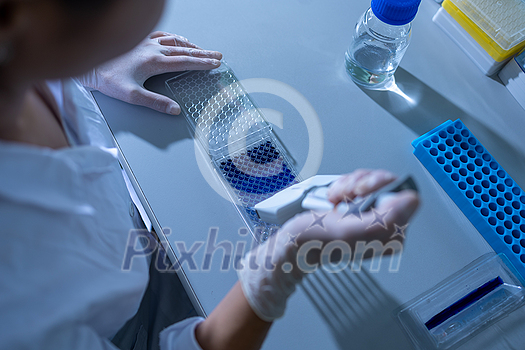 Female researcher carrying out research experiment in a chemistry lab Female researcher carrying out research experiment in a chemistry lab