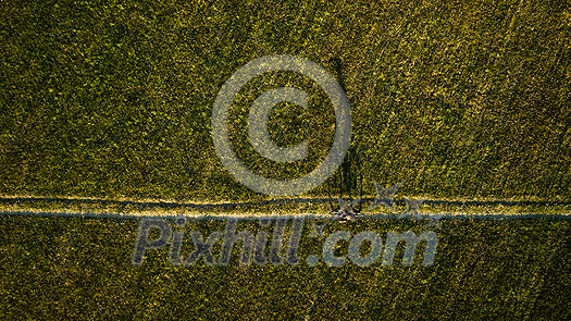 Aerial image of a biker on a mountain bike amid fields outdoors