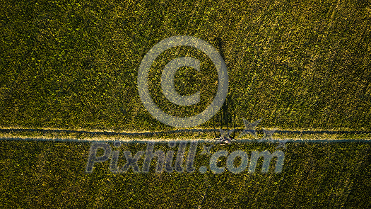 Aerial image of a biker on a mountain bike amid fields outdoors Aerial image of a biker on a mountain bike amid fields outdoors
