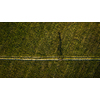 Aerial image of a biker on a mountain bike amid fields outdoors