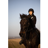 Female horse rider riding outdoors on her lovely horse