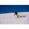 young athlete freestyle Skier having fun while running downhill in beautiful Alpine landscape on sunny day during winter season