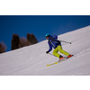 young athlete freestyle Skier having fun while running downhill in beautiful Alpine landscape on sunny day during winter season