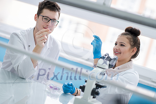 Group of young medical students doing research together in chemistry laboratory,teamwork by college student indoors
