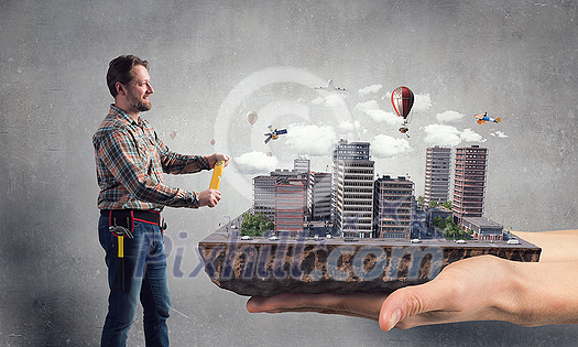 Builder man and his construction exterior model. Mixed media Builder man and his construction exterior model. Mixed media