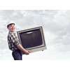 Young man carrying vintage TV set in hands. Mixed media