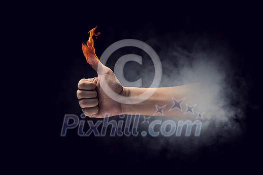 Young businessman holding fire flames in palm Young businessman holding fire flames in palm