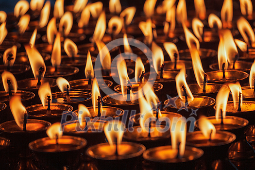 Burning candles in Buddhist temple. Dharamsala, Himachal Pradesh