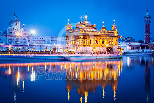 Sikh sacred site gurdwara Sri Harmandir Sahib (also known as The Golden Temple, also Darbar Sahib) illuminated at night. Amritsar, Punjab state, India