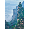 Famous tourist attraction of China - Zhangjiajie stone pillars cliff mountains in fog clouds with cable railway car lift at Wulingyuan, Hunan, China. With camera pan