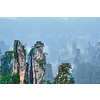 Famous tourist attraction of China - Zhangjiajie stone pillars cliff mountains in fog clouds at Wulingyuan, Hunan, China