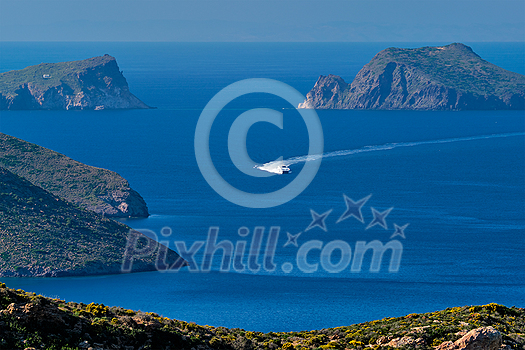 Speeding speed boat catamaran ferry vessel in Aegean sea near Milos island on summer day in Greece