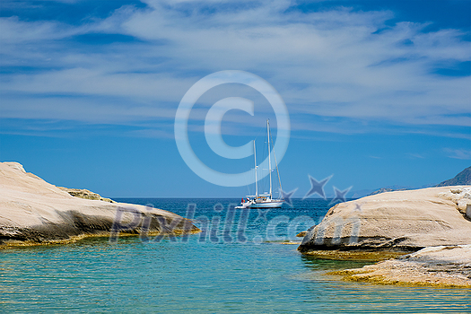 Greek holidays concept. Beautiful romantic island Milos. Yacht boat at Sarakiniko Beach, Milos island , Greece Greek holidays concept. Beautiful romantic island Milos. Yacht boat at Sarakiniko Beach, Milos island , Greece