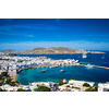 View of Mykonos town Greek tourist holiday vacation destination with famous windmills, and port with boats and yachts. Mykonos, Cyclades islands, Greece