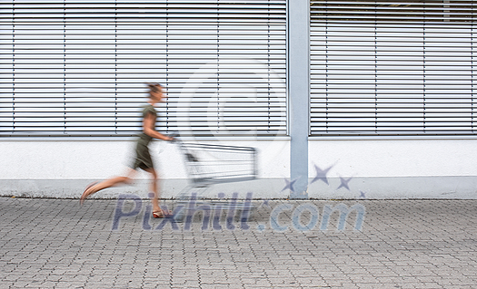 Pretty, young woman going grocery shopping with a trolley Pretty, young woman going grocery shopping with a trolley
