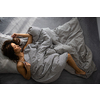 Pretty, young woman in her bed, fast asleep. Importance of sleep concept