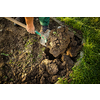 Senior gardener gardening in his permaculture garden - holding a spade