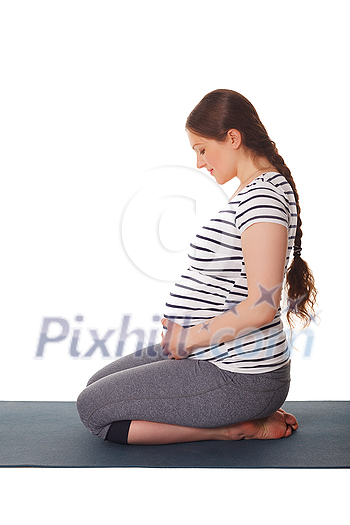 Pregnancy yoga exercise - pregnant woman doing yoga asana Virasana Hero Pose on knees isolated on white background Pregnancy yoga exercise - pregnant woman doing yoga asana Virasana Hero Pose on knees isolated on white background