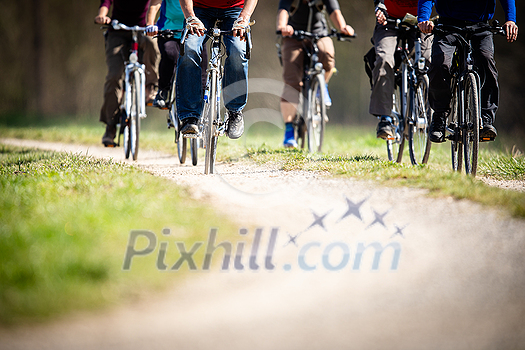 Group of people biking outdoors on a lovely spring day Group of people biking outdoors on a lovely spring day