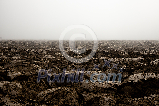 Fertile, dark soil, field after plowing. Getting ready for the next growing season being turned by plowing