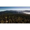 Mountain atmospheric landscape of high mountains in thick fog in rainy weather, panorama of mountain tops in thick clouds, dawn in the mountains in early spring.