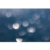 Abstract background with reflections on water and soft blue bokeh.