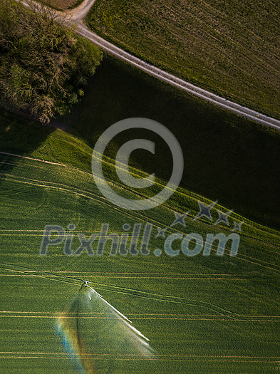 Farmland from above - aerial image of a lush green field being irrigated Farmland from above - aerial image of a lush green field being irrigated