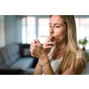 Mid-aged woman lighting a cigarette at home, getting her nicotine daily dose, unable to resist to her unhealthy habit