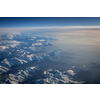 View from a cockpit of a commercial airliner airplane over a beautiful mountain range