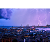 Evening view of Genoa (Genova) port, Italy with port cranes and industrial zone in thunderstorm with lighting. Genoa, Italy