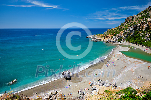 View of Preveli beach on Crete island with relaxing people and Mediterranean sea. Crete island, Greece View of Preveli beach on Crete island with relaxing people and Mediterranean sea. Crete island, Greece