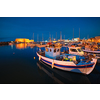 Venetian Fort Venetian fortress of Koules Castello a Mare castle in Heraklion and moored Greek fishing boats in port, Crete Island, Greece in the evening