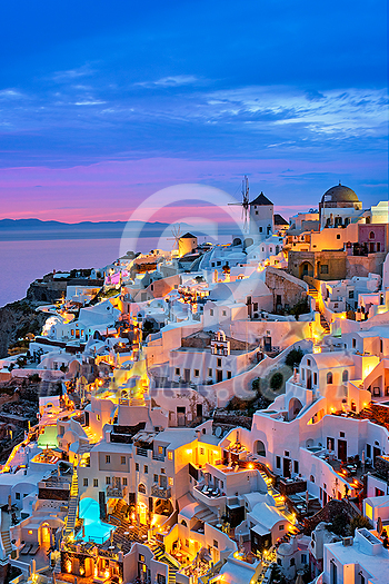 Famous greek iconic selfie spot tourist destination Oia village with traditional white houses and windmills in Santorini island in the evening blue hour, Greece Famous greek iconic selfie spot tourist destination Oia village with traditional white houses and windmills in Santorini island in the evening blue hour, Greece