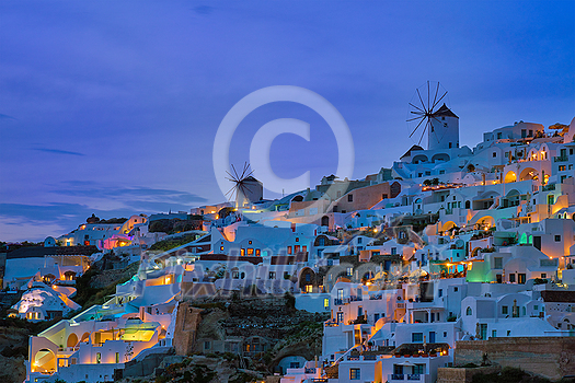 Famous greek iconic picturesque tourist destination Oia village with traditional white houses and windmills in Santorini island in the evening blue hour, Greece Famous greek iconic picturesque tourist destination Oia village with traditional white houses and windmills in Santorini island in the evening blue hour, Greece