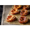 Freshly baked home soft pretzel with salt on craft paper for baking