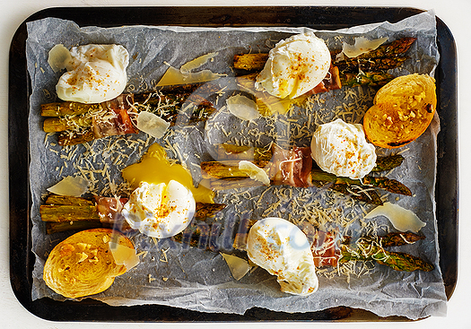 Asparagus in bacon with egg poached, croutons and Parmesan cheese. Top view. Asparagus in bacon with egg poached, croutons and Parmesan cheese. Top view.